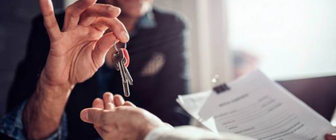 Landlord Handing Over Keys And Contract To A New Tenant